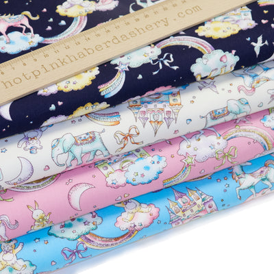 100% cotton poplin fabric by Rose and Hubble with unicorns, rainbows, castles and elephants in Navy, Ivory, Pink and Sky Blue