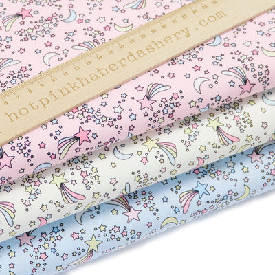 Shooting stars and moon print cute and magical children's 100% cotton poplin Rose and Hubble Fabric in ivory, pink and sky blue. 
