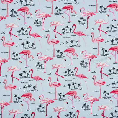 Swatch of exotic flamingo and palm tree printed 100% cotton poplin fabric by Rose and Hubble in pale blue