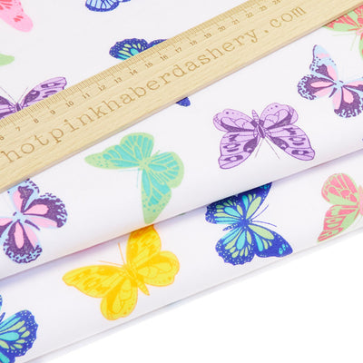 Dancing, elegant butterfly printed polycotton fabric in yellow and purple on white