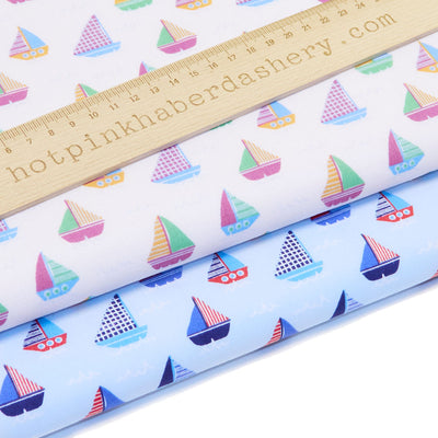 Colourful seaside yachts with cross-hatch stripe and spot details on polycotton fabric in white and sky blue