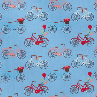 Swatch of colourful bicycles and balloons print 100% cotton poplin fabric in blue.