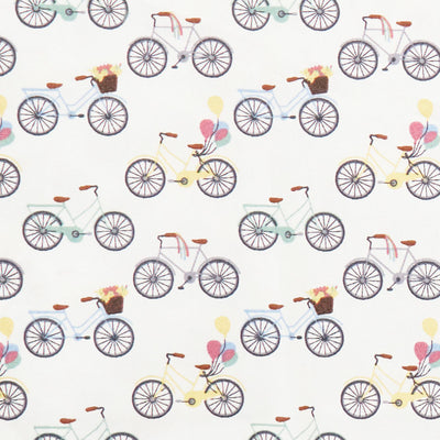 Swatch of colourful bicycles and balloons print 100% cotton poplin fabric in white.