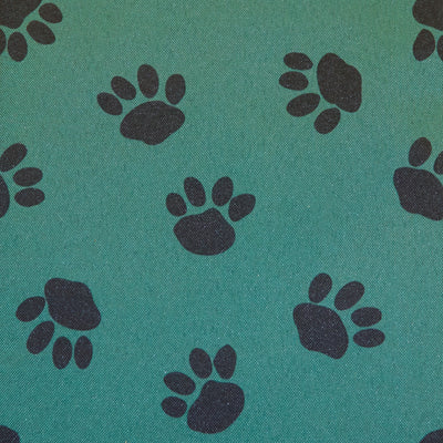 Swatch of outdoor waterproof PU 100% polyester fabric in paw pet dog print in green