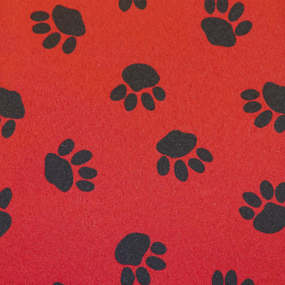 Swatch of outdoor waterproof PU 100% polyester fabric in paw pet dog print in red