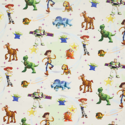 Swatch of light cream Disney Toy Story 100% cotton fabric by Chatham Glyn