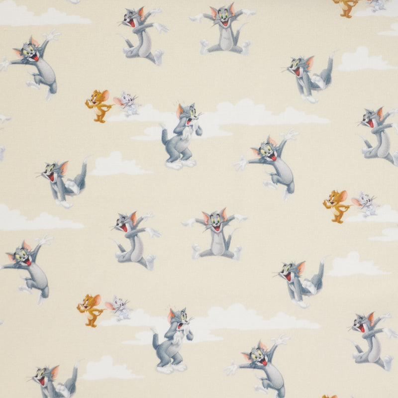 Swatch of Tom and Jerry cartoon 100% cotton fabric by Chatham Glyn on beige background