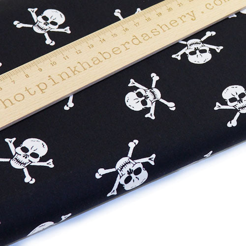 Pirate skull and crossbones playful printed 100% cotton poplin fabric by Rose and Hubble in black and white