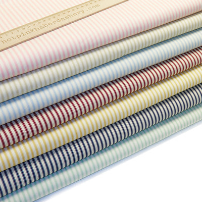 Elegant ticking stripes on a cream base iin 100% cotton poplin fabric by Rose and Hubble in Red, Pink, Tan, Navy, Blue & Yellow