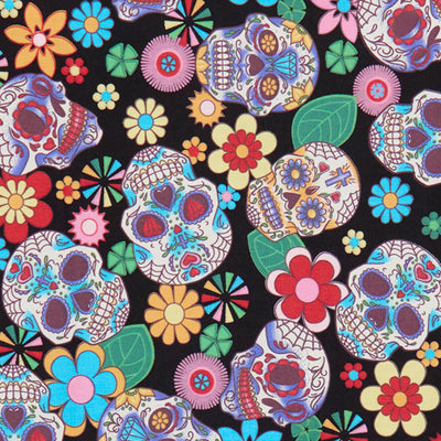 Swatch of Mexican festival-inspired 'Dia De Los Muertos' print with skulls and flowers on 100% cotton poplin fabric by Rose and Hubble in Black and multicolour, Halloween fabric, skull fabric