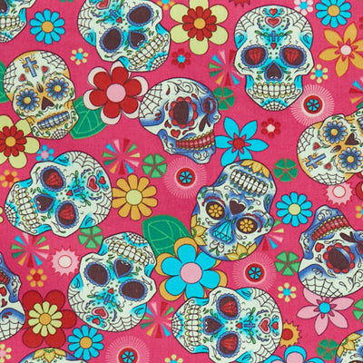Swatch of Mexican festival-inspired 'Dia De Los Muertos' print with skulls and flowers on 100% cotton poplin fabric by Rose and Hubble in cerise pink and multicolour, Halloween fabric, skull fabric