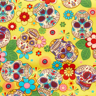 Swatch of Mexican festival-inspired 'Dia De Los Muertos' print with skulls and flowers on 100% cotton poplin fabric by Rose and Hubble in yellow and multicolour, Halloween fabric, skull fabric