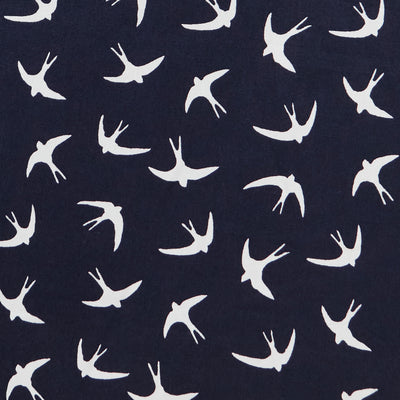 Swatch of bold white flying swallow birds print in 100% cotton poplin by Rose and Hubble in Navy blue