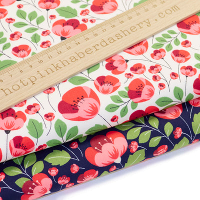 Poppy print Rose and Hubble 100% cotton poplin fabric in navy and ivory with red poppies and green leaves 