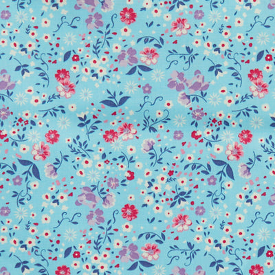 Swatch of fun, summer flowers and leaves printed 100% cotton poplin fabric by Rose and Hubble in Pastel Blue