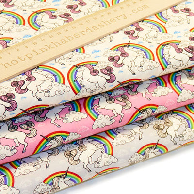Magical, unicorns and rainbows with clouds on 100% cotton poplin fabric by Rose and Hubble in pink, silver and ivory