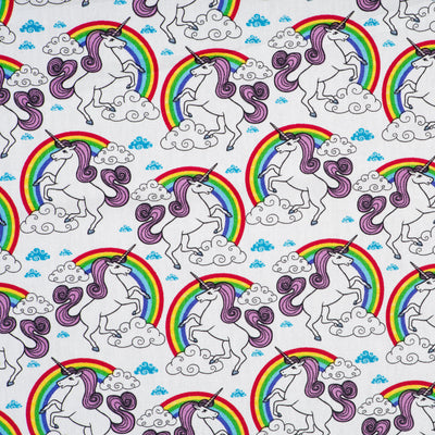 Swatch of magical, unicorns and rainbows with clouds on 100% cotton poplin fabric by Rose and Hubble in ivory