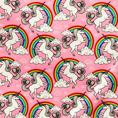 Swatch of magical, unicorns and rainbows with clouds on 100% cotton poplin fabric by Rose and Hubble in pink