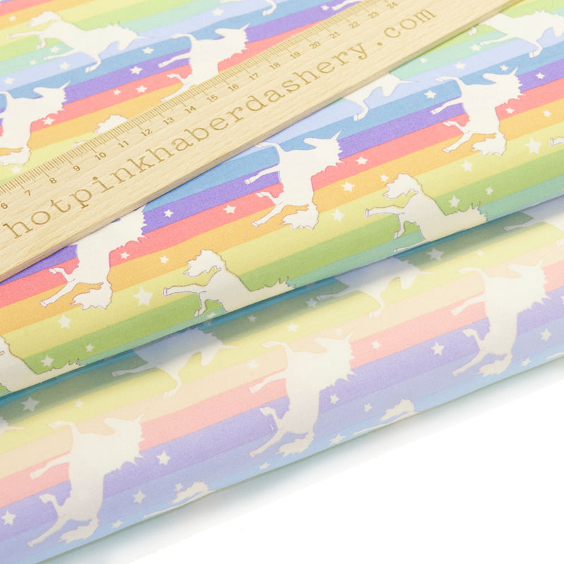 Funky, magical rainbow stripes and unicorns with stars on 100% cotton poplin fabric by Rose and Hubble in multicoloured pastel and brights