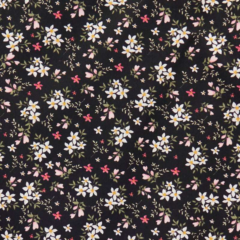 Swatch of 100% cotton poplin fabric by Rose and Hubble with star flower bouquets, leaves and buds in black
