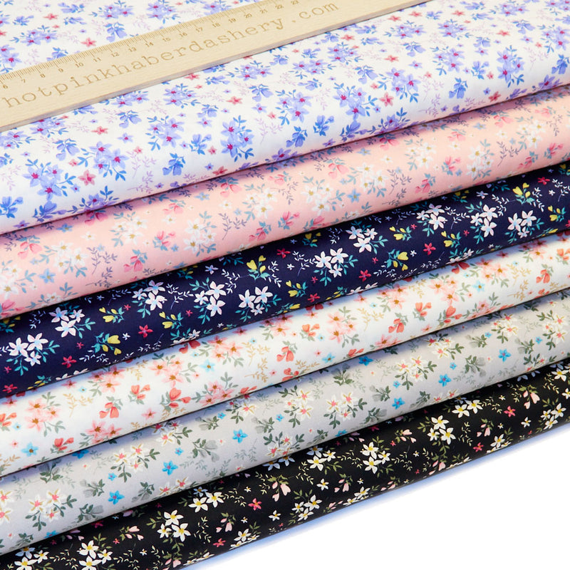 100% cotton poplin fabric by Rose and Hubble with star flower bouquets, leaves and buds. In colours Pink, Coral, Grey, Navy, Black & Blue.