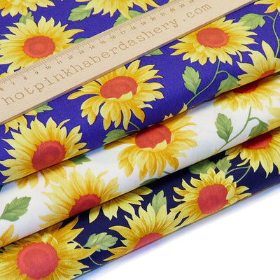 Bold and colourful, yellow sunflower print 100% cotton poplin fabric by Rose and Hubble. In colours Ivory, Royal Blue & Navy