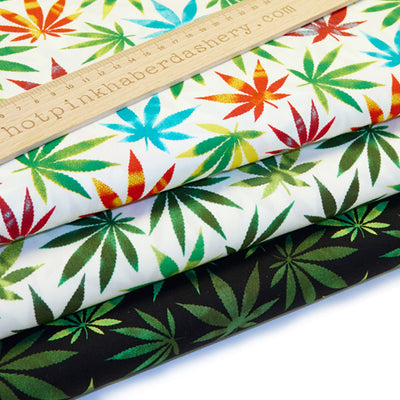 Bold and colourful cannabis leaf print 100% cotton poplin fabric by Rose and Hubble on black, ivory and multicolour