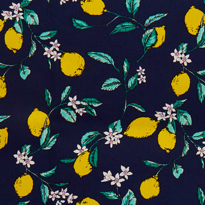 Swatch of illustrated lemon, leaves and flower print 100% cotton poplin fabric by Rose and Hubble in Navy blue and yellow