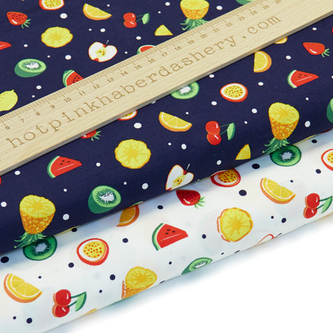 Funky fruit print with kiwis, watermelons, oranges, cherries, lemons, pineapples, strawberries & apples on 100% cotton poplin fabric by Rose and Hubble on navy blue and white