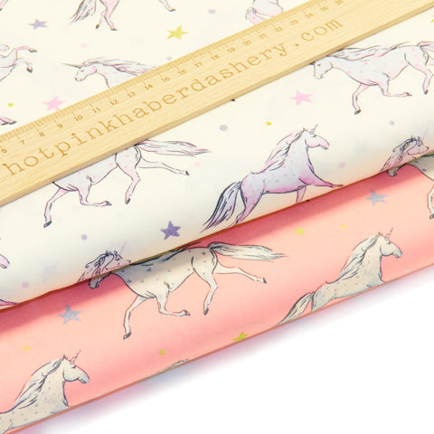Cute, magical prancing unicorn with stars print 100% cotton poplin fabric by Rose and Hubble in ivory and pink 