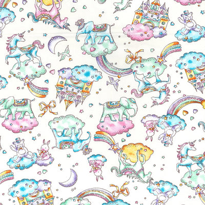 Swatch of 100% cotton poplin fabric by Rose and Hubble with unicorns, rainbows, castles and elephants in Ivory