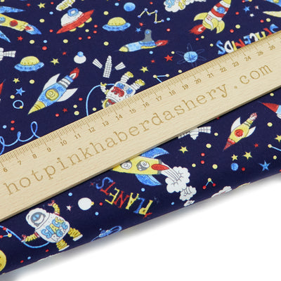 Navy blue children's colourful space print 100% cotton poplin fabric with rockets, UFO's and stars by Rose and Hubble. Space fabric, children's fabric.