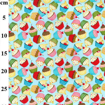 Swatch of funky and colourful cupcake print 100% cotton poplin fabric by Rose and Hubble in Blue