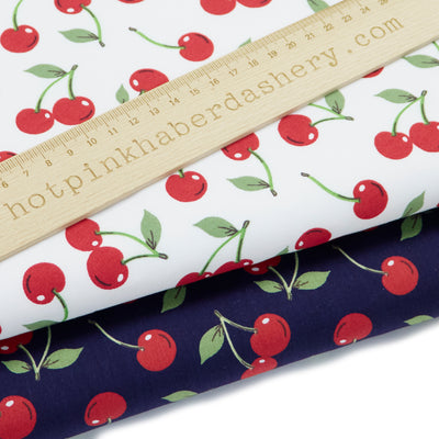 Stylish red cherry fruit and green leaves 100% cotton poplin fabric by Rose & Hubble in navy and ivory