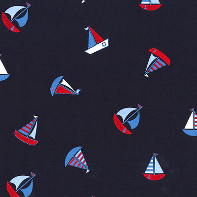 Swatch of fun, nautical sailing boats in shiny foil with stripes and anchors on jersey fabric by John Louden in navy blue