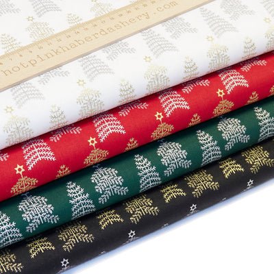 Scandi-style 100% cotton poplin fabric by John Louden with elegant gold and silver Christmas trees by Rose and Hubble in Navy Blue, White, Red and Green.