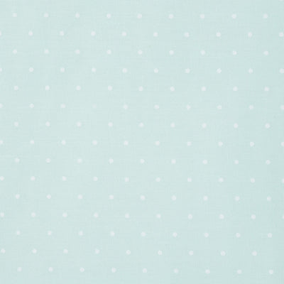 Swatch of small classic polka dot printed polycotton fabric in pastels in mint green