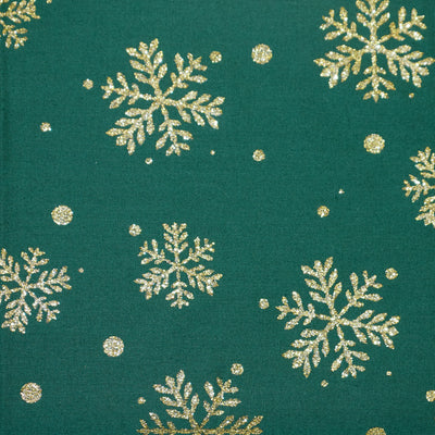 Swatch of Christmas gold glitter snowflake print 100% cotton poplin Rose & Hubble fabric in green.