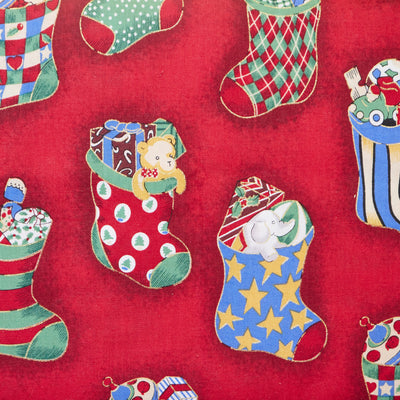 Swatch of classic festive toys In Christmas Stockings printed Rose & hubble 100% Cotton poplin fabric in red