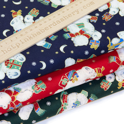 Cute, classic polar bears with Christmas presents, moons and snowflakes on 100% cotton poplin fabric by Rose & Hubble in red, navy blue and green