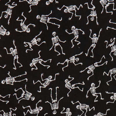 Swatch of dancing, spooky Halloween skeletons on polycotton fabric in white and black