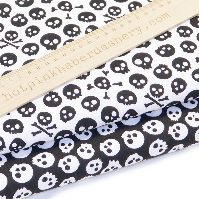 Spooky skulls Halloween print polycotton fabric in black and white