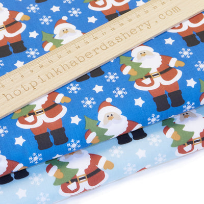 Classic Santa fabric with Christmas tree, snowflakes and stars polycotton fabric in blue night and day