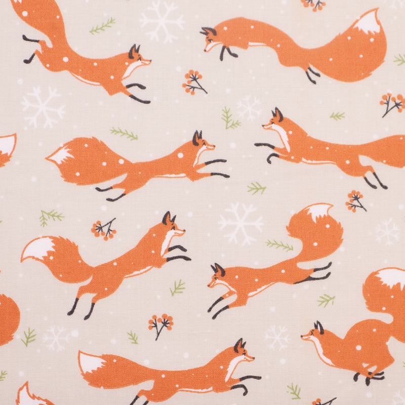 Swatch of playful Christmas winter foxes with festive snowflakes on polycotton fabric in cream