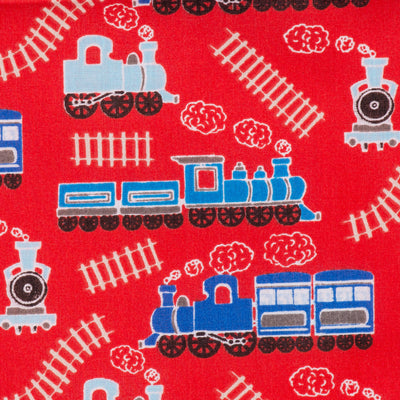 Swatch of children's steam trains and tracks printed polycotton fabric in red, blue and white